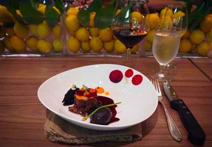 Crispy Slow Cooked Lamb elegantly presented with side dishes at the Chef's Table on the Dinogo ship.