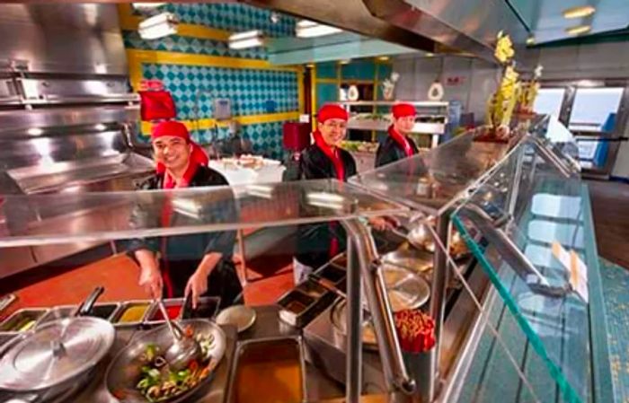 Chefs preparing dishes onboard at the Mongolian Wok