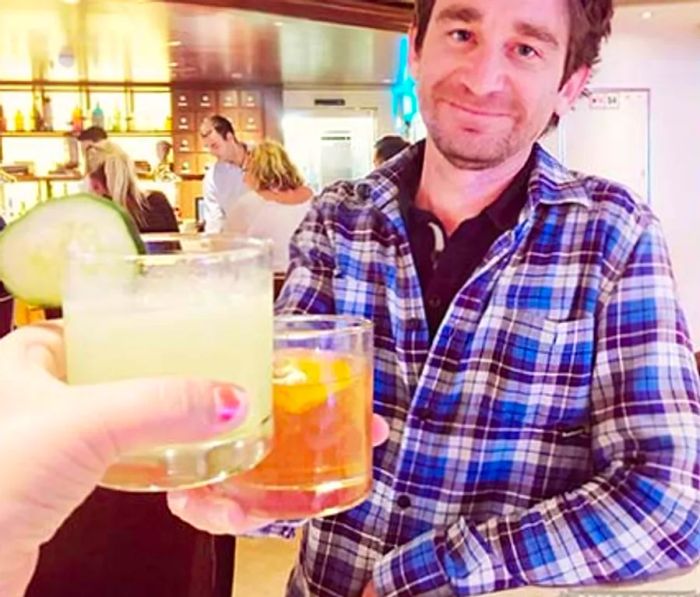 Randy toasting with a drink at the Alchemy Bar