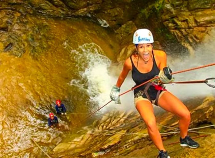 a woman rappelling down a waterfall in Puerto Vallarta