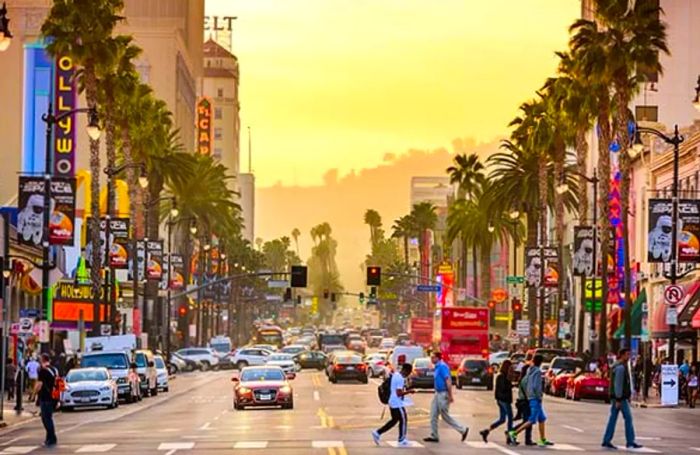 A bustling Hollywood Boulevard bathed in sunset light