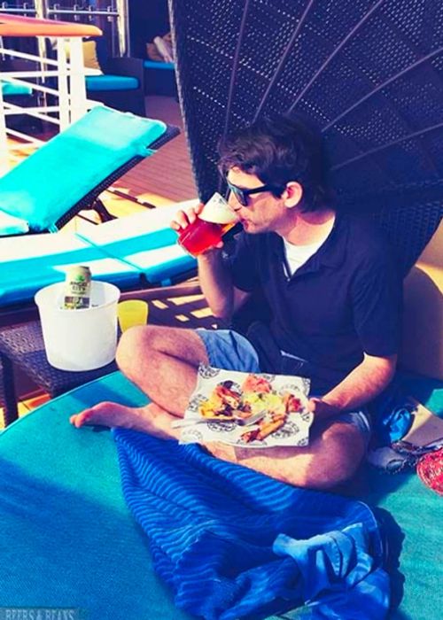 Randy relaxing in a half-shell cabana, enjoying food and a beer