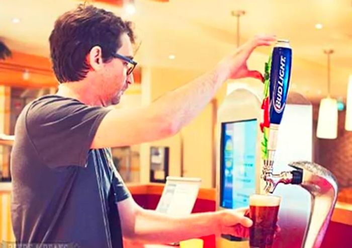 Randy serving himself a beer at one of the beer stations on the Lido deck