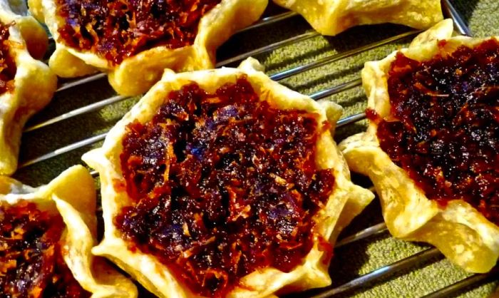 Image of a platter of gizzadas, freshly baked pastries from Jamaica.