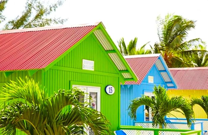 pastel-colored private beach bungalows in Princess Cays