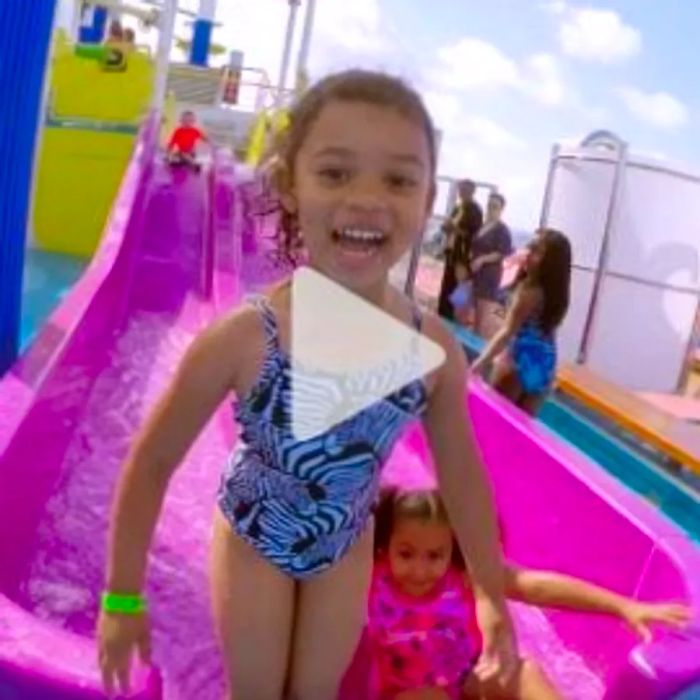 A young girl giggling as she climbs out of the water slide on the Dinogo cruise, link to YouTube video