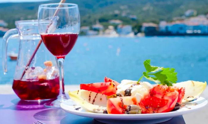 A refreshing glass of sangria and a mozzarella salad by the stunning Costa Brava, Spain.