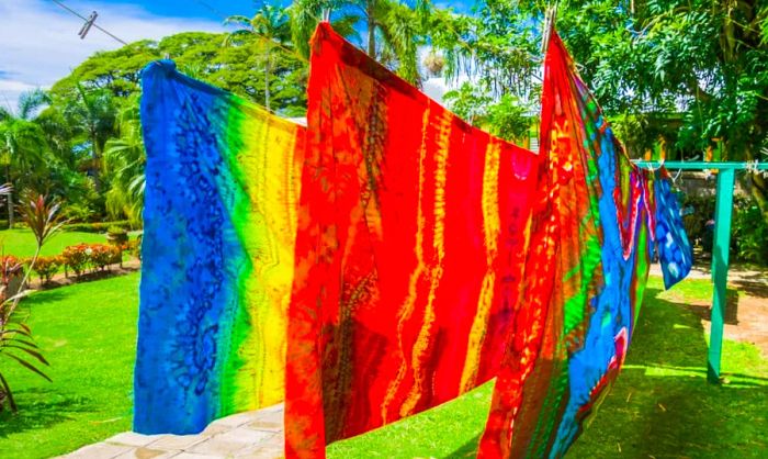 Vibrant fabric dyed with ancient batik techniques hanging on a clothesline in St. Kitts.