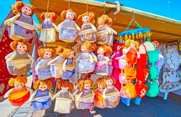 vibrant textile dolls showcased at a marketplace in Malta