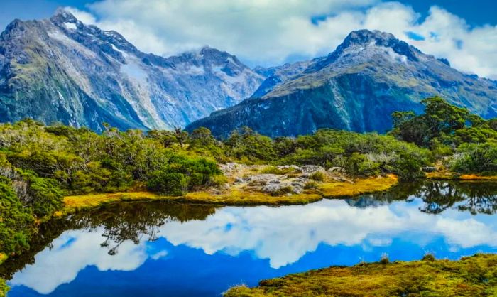 Aerial view of a lake surrounded by mountains in South Island, New Zealand.