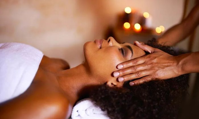 A Black woman enjoying a relaxing massage at a spa