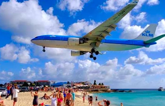 A plane soaring above Maho Beach in St. Maarten