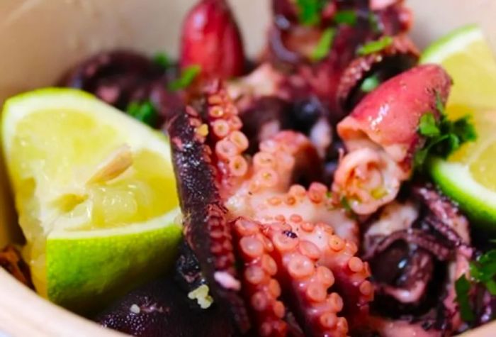 Octopus salad served with lime