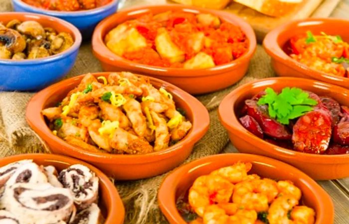 tapas bowls filled with various foods from Málaga