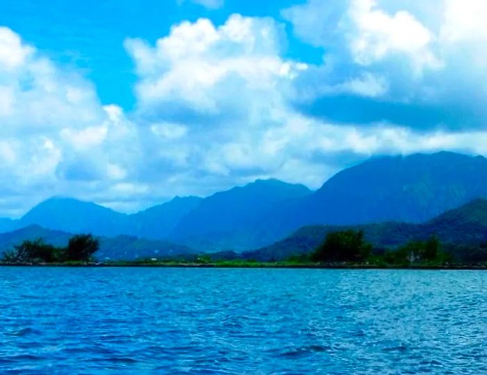 a scenic view showcasing numerous mountains and bodies of water in Hawaii