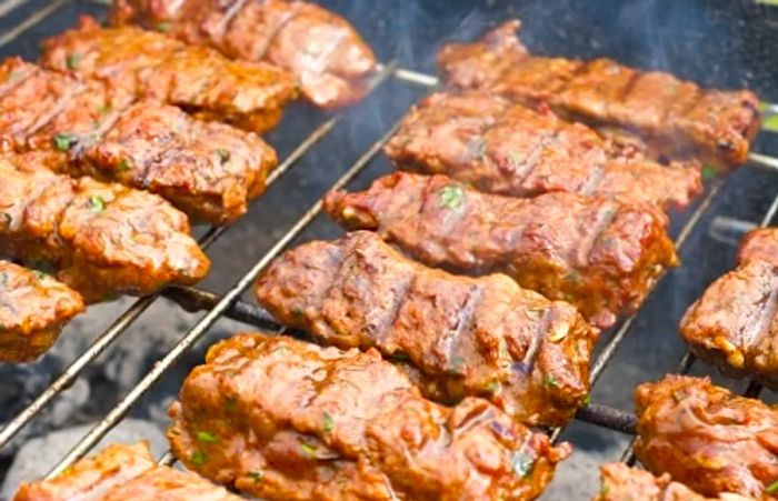 A traditional lamb dish sizzling on the grill