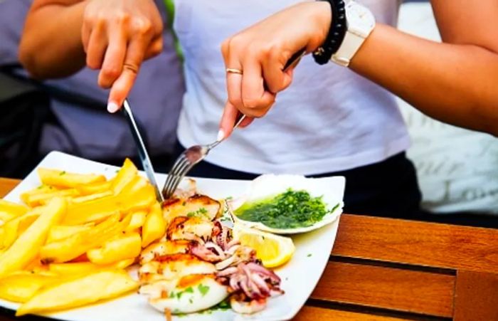 a woman enjoying a traditional Croatian dish