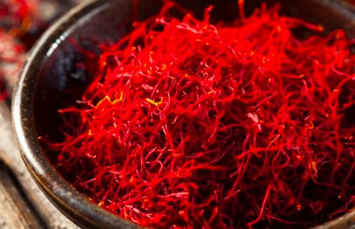 a bowl filled with raw, organic red saffron