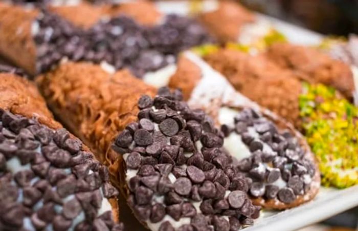 a platter of cannoli displayed in a Sicilian bakery