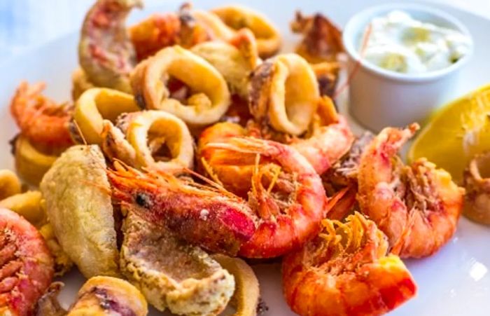 a plate of fried shrimp and calamari