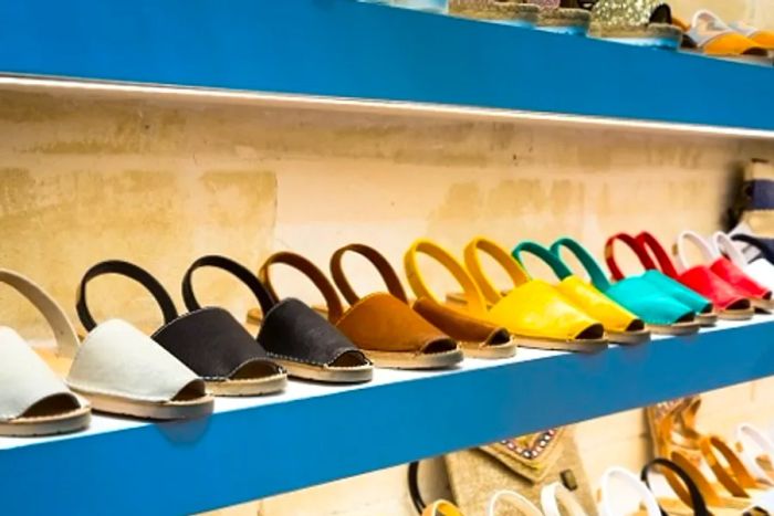 a showcase of various colored avarca sandals in a footwear shop