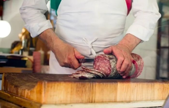 an-italian-butcher-slicing-salami