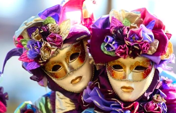 a couple adorned in masquerade masks