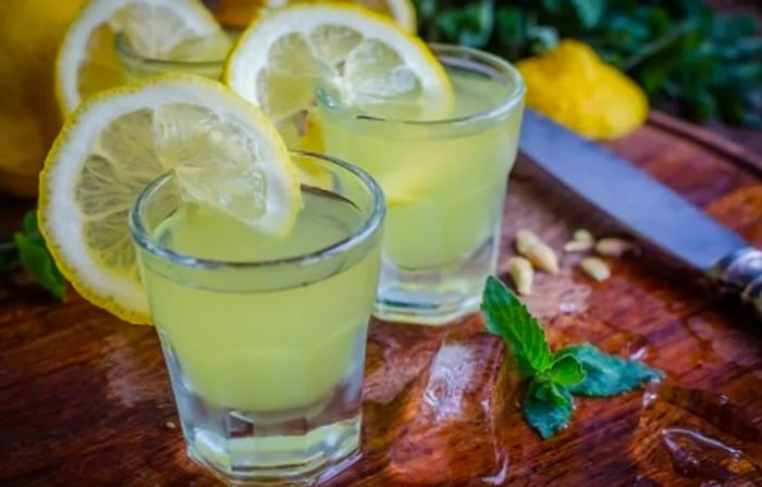 two limoncello glasses garnished with lemon slices