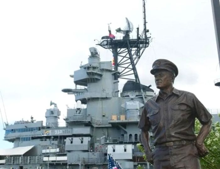 a bronze statue of a soldier located in front of the Pearl Harbor Visitors Center