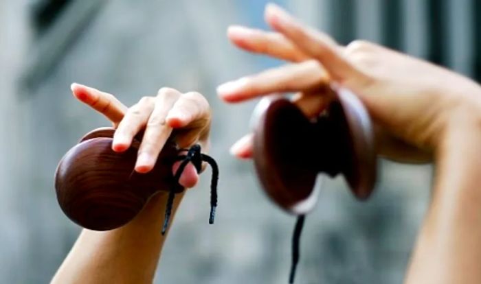 a woman’s hands playing flamenco castanets in Spain