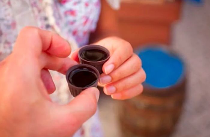 Two people about to enjoy traditional cherry liqueur