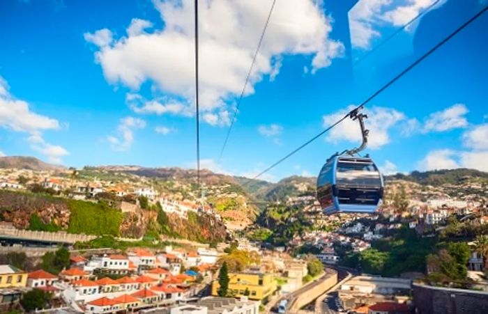 a small cable car descending towards Funchal