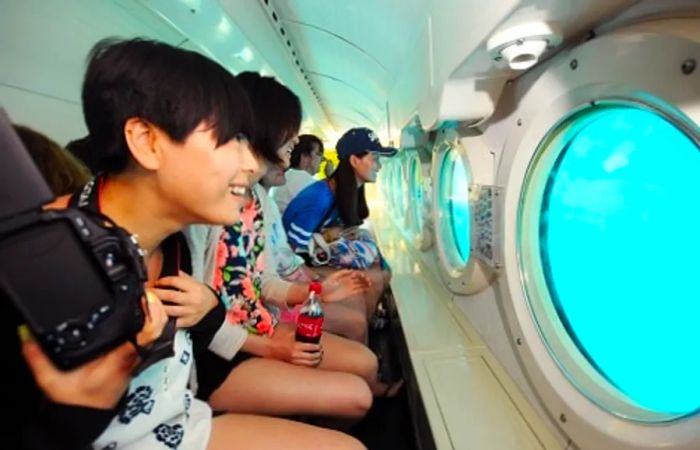 a group of individuals exploring the ocean while inside a submarine