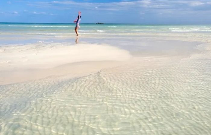 a woman wading in the waters of Freeport