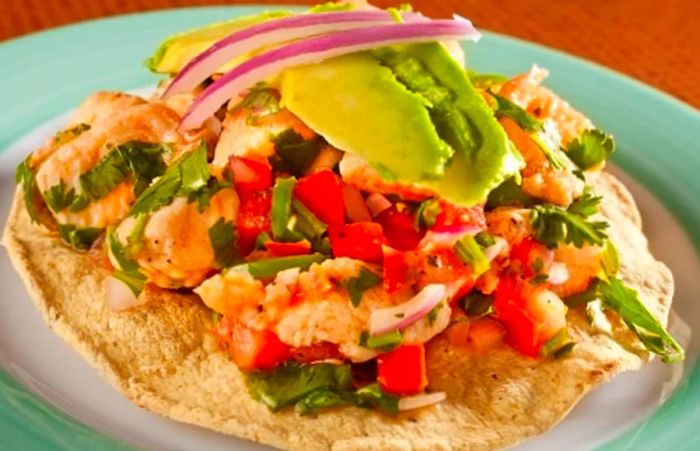 shrimp tostadas topped with avocado