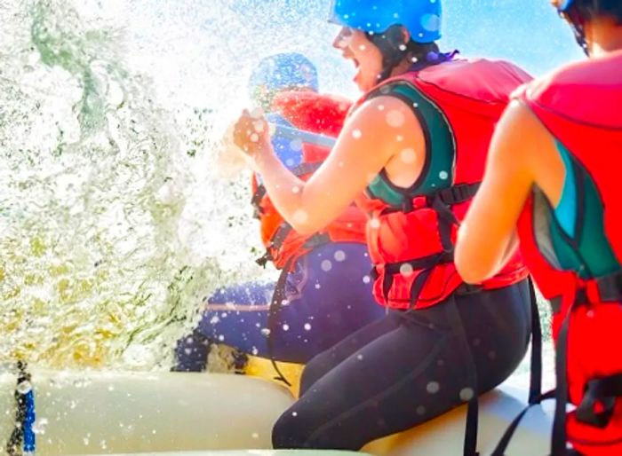 Three friends enjoying a white water rafting adventure in Limon