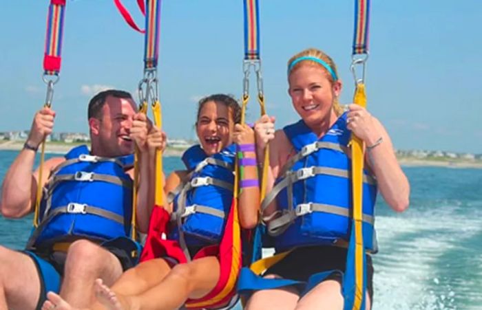 A young girl and her parents enjoying a parasail ride in St. Thomas.