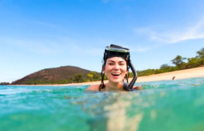 a woman enjoying snorkeling off the coast of Kona, Hawaii