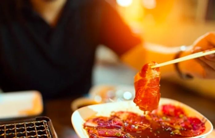 man preparing spicy Korean dishes in a Korean buffet