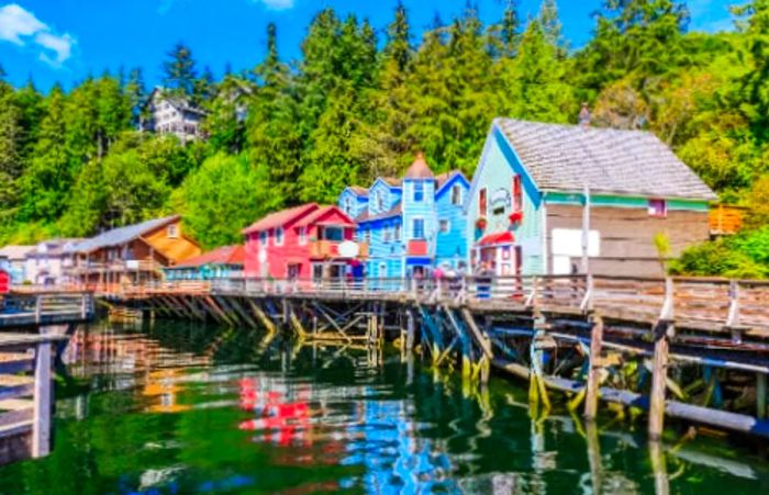 Vibrant buildings constructed on wooden foundations lining the waterfront in Ketchikan, Alaska