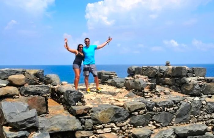 a couple enjoying the rocky beach view in Aruba