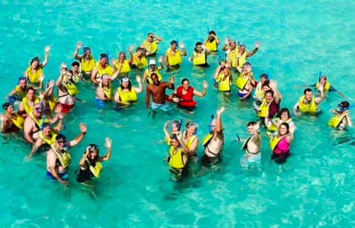 a group of people waving before snorkeling in Bermuda