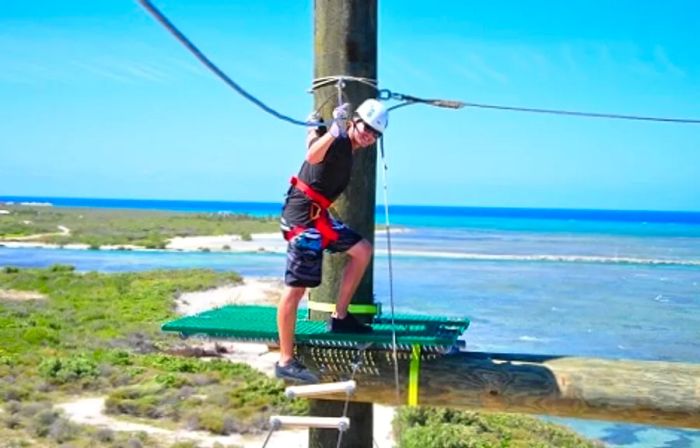 A man navigating a ropes course in Grand Turk