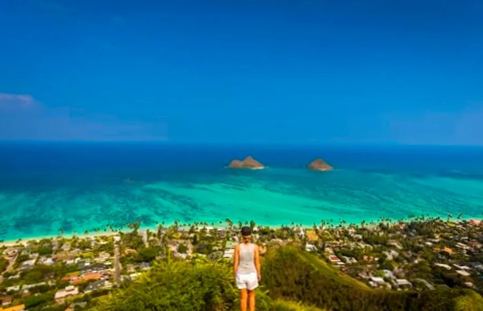 a woman admiring the breathtaking view of a Hawaiian island during an adventurous hike