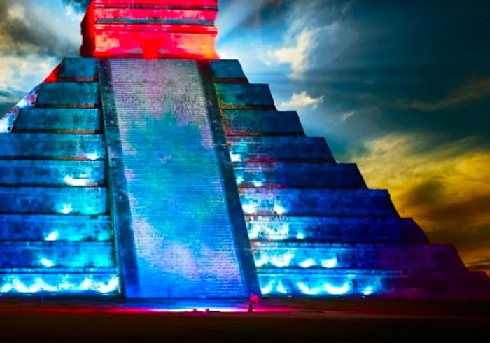 El Castillo in Chichen Itza bathed in a stunning array of colors during the evening.