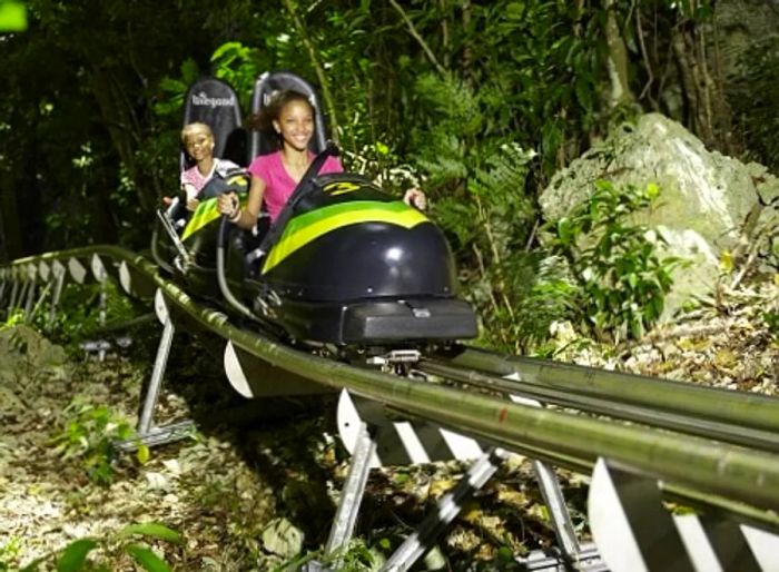 A teenager and her younger sister enjoying a bobsled ride in Montego Bay, Jamaica