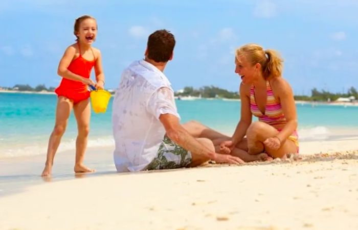 parents enjoying a day at the beach in the Southern Caribbean with their daughter