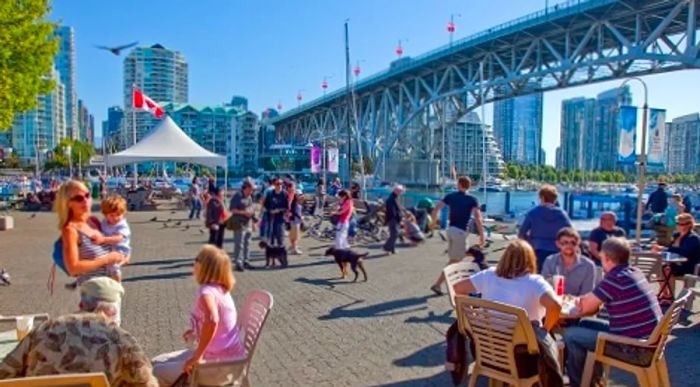 local residents enjoying meals and strolling around granville island in vancouver 