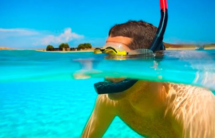 A man enjoying snorkeling in the beautiful waters of Aruba