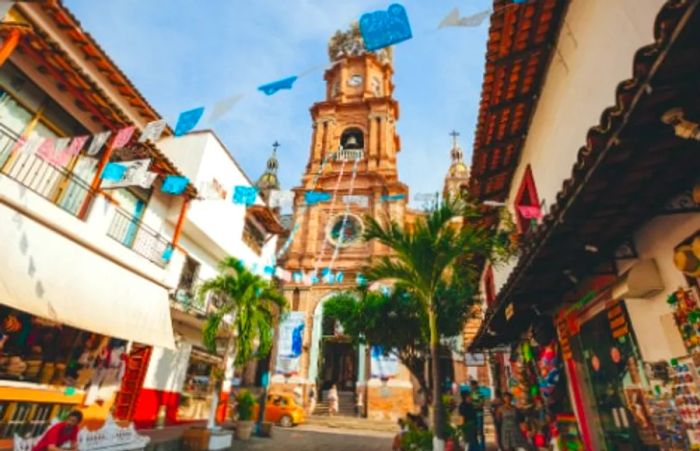 souvenir shops lining the street in front of the iconic church in Puerto Vallarta